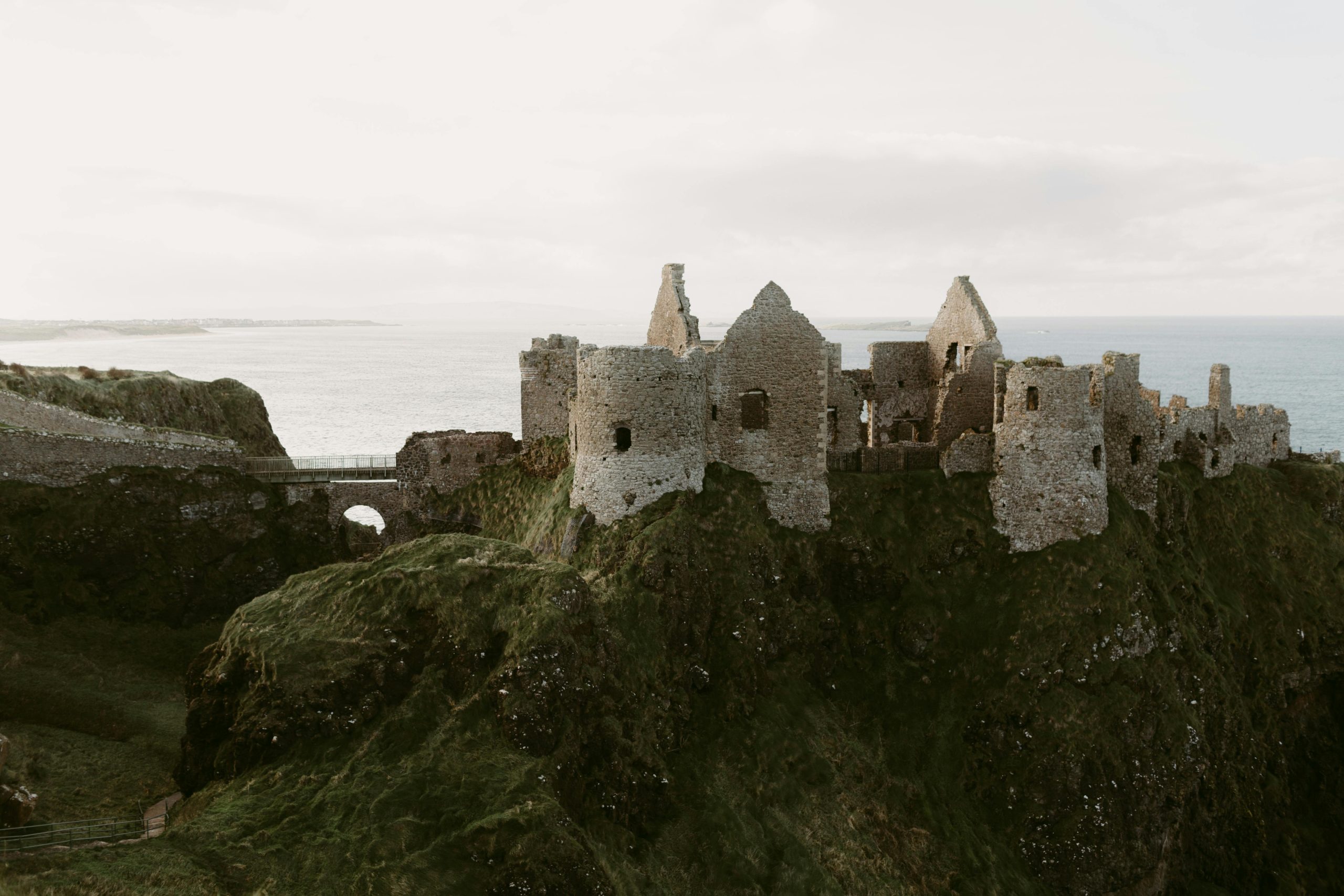 Explore the captivating ruins of Dunluce Castle overlooking the sea in Northern Ireland.